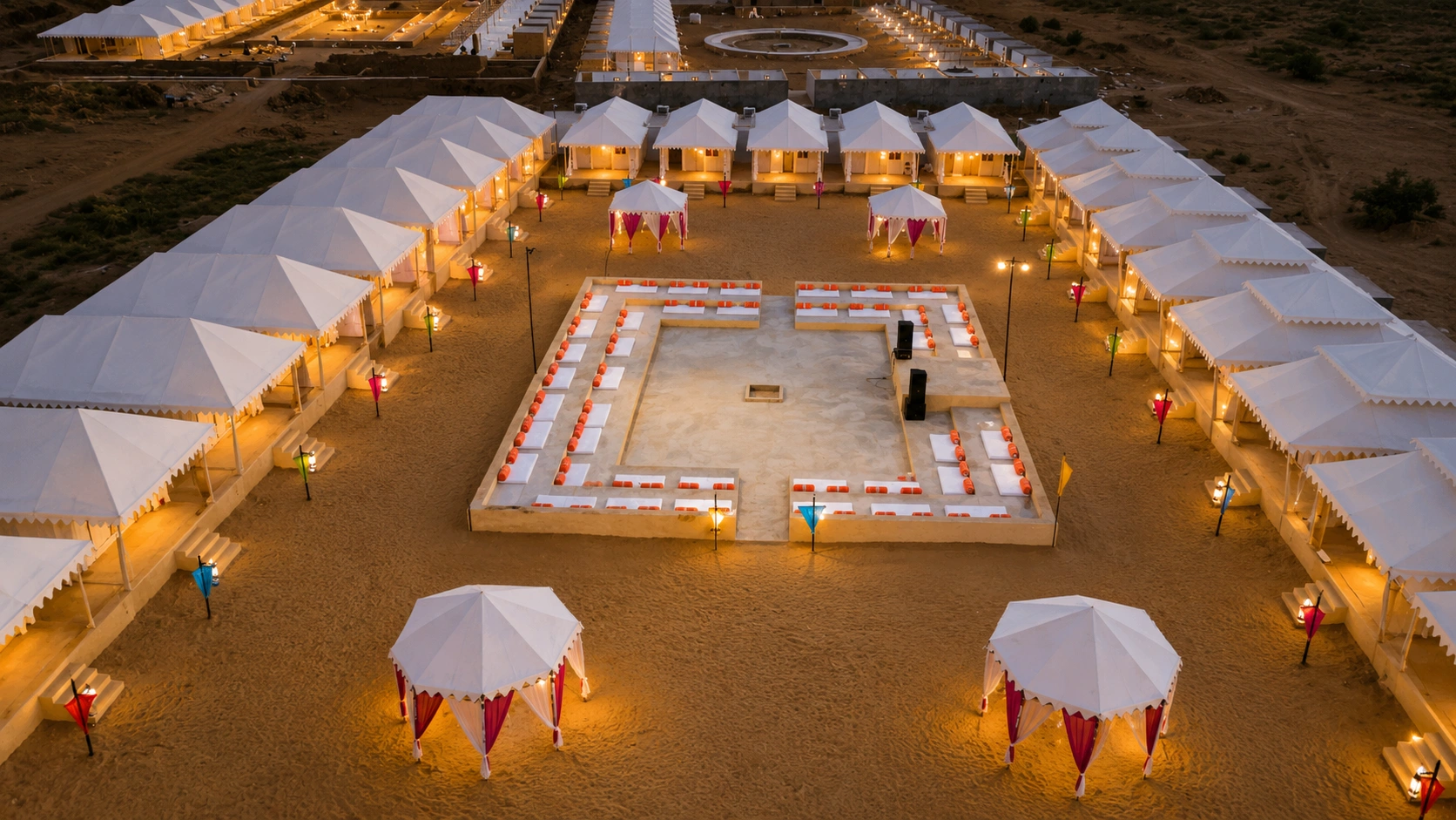 Aerial view of the desert camp and its central lounge at dusk